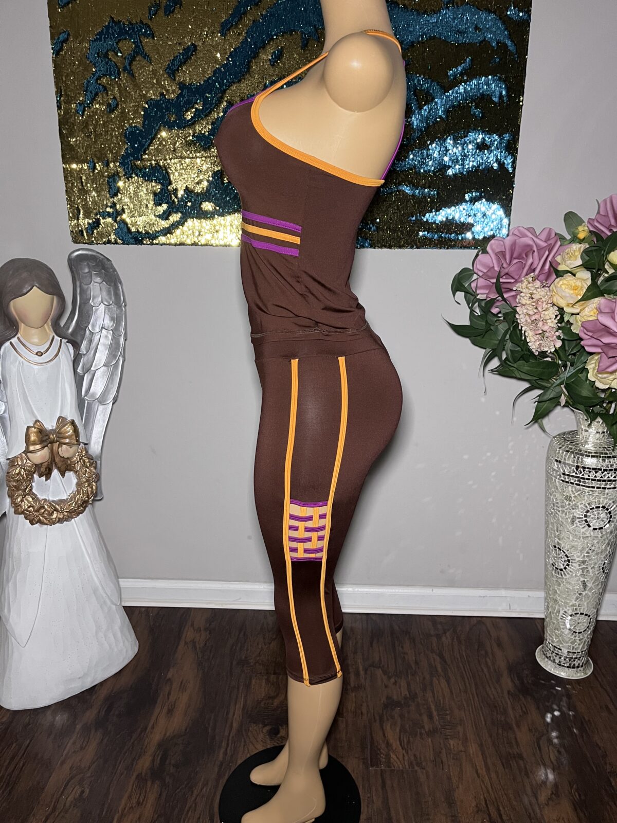 kokoa rich brown two piece kissed with bold purple and orange abstract moments that scream spring without saying a word. the cropped ankle length pants feature a sleek checkerboard detail down the sides, perfectly paired with a statement top that turns heads from the front and the back. it’s the kind of set you can’t fully explain… you just feel it. and when you put her on? oh, they’ll understand. ultra comfortable. fully compressive. effortlessly striking. kokoa rich brown two piece kissed with bold purple and orange abstract moments that scream spring without saying a word. the cropped ankle length pants feature a sleek checkerboard detail down the sides, perfectly paired with a statement top that turns heads from the front and the back. it’s the kind of set you can’t fully explain… you just feel it. and when you put her on? oh, they’ll understand. ultra comfortable. fully compressive. effortlessly striking.